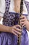 Woman in dirndl dress playing clarinet, detail