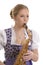 Woman in dirndl dress playing saxophone