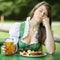 Woman in dirndl sitting in beer garden and sleeps