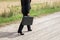 Woman on the dirt road with briefcase