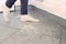 Woman on the dirty floor in the kitchen. Leftovers and crumbs on the kitchen floor. Legs close-up.