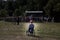 A woman with disabilities watches a crowd of people