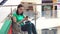 A woman with a disability in a wheelchair uses the phone at the Mall after shopping.Close up