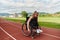 A woman with disablity driving a wheelchair on a track while preparing for the Paralympic Games