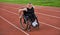 A woman with disablity driving a wheelchair on a track while preparing for the Paralympic Games