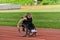 A woman with disablity driving a wheelchair on a track while preparing for the Paralympic Games