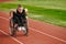 A woman with disablity driving a wheelchair on a track while preparing for the Paralympic Games