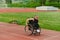 A woman with disablity driving a wheelchair on a track while preparing for the Paralympic Games