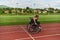 A woman with disablity driving a wheelchair on a track while preparing for the Paralympic Games