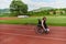 A woman with disablity driving a wheelchair on a track while preparing for the Paralympic Games