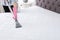 Woman disinfecting mattress with vacuum cleaner, closeup.