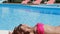 Woman dissolve her hair on the poolside