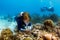 Woman diver photographing the reef