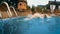 woman dives into a swimming pool in the mountains at sunset. HD