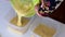 A woman divides cooked dough into two containers.