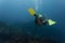 Woman diving with sharks in open water