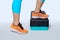Woman do exercise on a black-turquoise fitness step