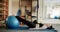 A woman do muscular exercises on fitness toning ball. in a physiotherapy studio