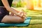 Woman do yoga practice meditating in park nature, close up cropped photo lotus position. No stress, mindfulness, inner balance