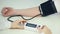 Woman doctor checking patient\'s blood pressure using sensor, health monitoring