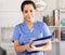 Woman doctor with clipboard meeting patients