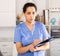 Woman doctor with clipboard meeting patients