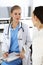 Woman - doctor consults her female patient while using clipboard and medication history record. Medicine concept