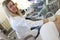 Woman doctor doing ultrasound examination of kidneys to female patient in clinic