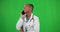 Woman, doctor and green screen for phone call and communication for care. Happy black person or healthcare professional