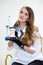 woman doctor in hands with articulator and jaw smart watch white coat beautiful makeup white background advertising