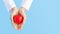 Woman doctor hands holding red heart on wide blue background donate for foundation hospital blood care concept Panoramic world