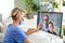 Woman doctor having video call with husband and son, social distancing concept.