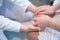 Woman doctor holds hands with a young patient