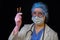 Woman doctor holds syringes in his hand on a black background, concept. Female nurse with syringes for injection against