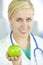 Woman Doctor in Hospital Holding Green Apple