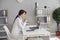 Woman doctor listens to the patient using laptop video camera in clinic office.