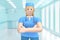 Woman doctor in the medical interior of the hospital stands with hands clasped on her chest. Cartoon person . 3D rendering