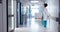 Woman, doctor and medical service in hospital hallway, healthcare and wellness in corridor. Female nurse, watch and
