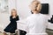 Woman doctor pediatrician talking to kid girl patient at medical checkup