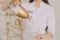 Woman doctor pours water from a glass bottle into a glass