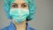 Woman doctor in protective mask blue uniform, first medical aid, occupation