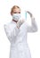 Woman doctor in respirator hands vial with liquid