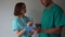 Woman doctor signs the documents in a folder in the hands of its young intern. Doctor and intern, medical assistant