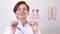 Woman doctor with a stethoscope takes off his glasses. smiling at the camera