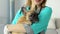 Woman doctor veterinarian holding a small dog in her arms. Close up