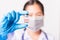 Woman doctor  wearing face mask protective in laboratory holding vial corona vaccine bottle