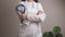 A woman doctor in a white coat holds a stethoscope in her hands, treatment and examination in a clinic, medical