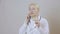 Woman doctor in a white coat talking on the phone