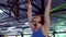 Woman does kipping pull ups