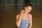 A woman does self - massage with a small ball while sitting in a fitness room . Myofascial relaxation